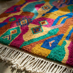 Fringe and edge detail of the Awrir magenta Boujaad rug.
