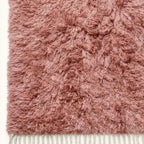 Mauve Beni Ourain rug edge detail with ivory fringe trim and pile texture