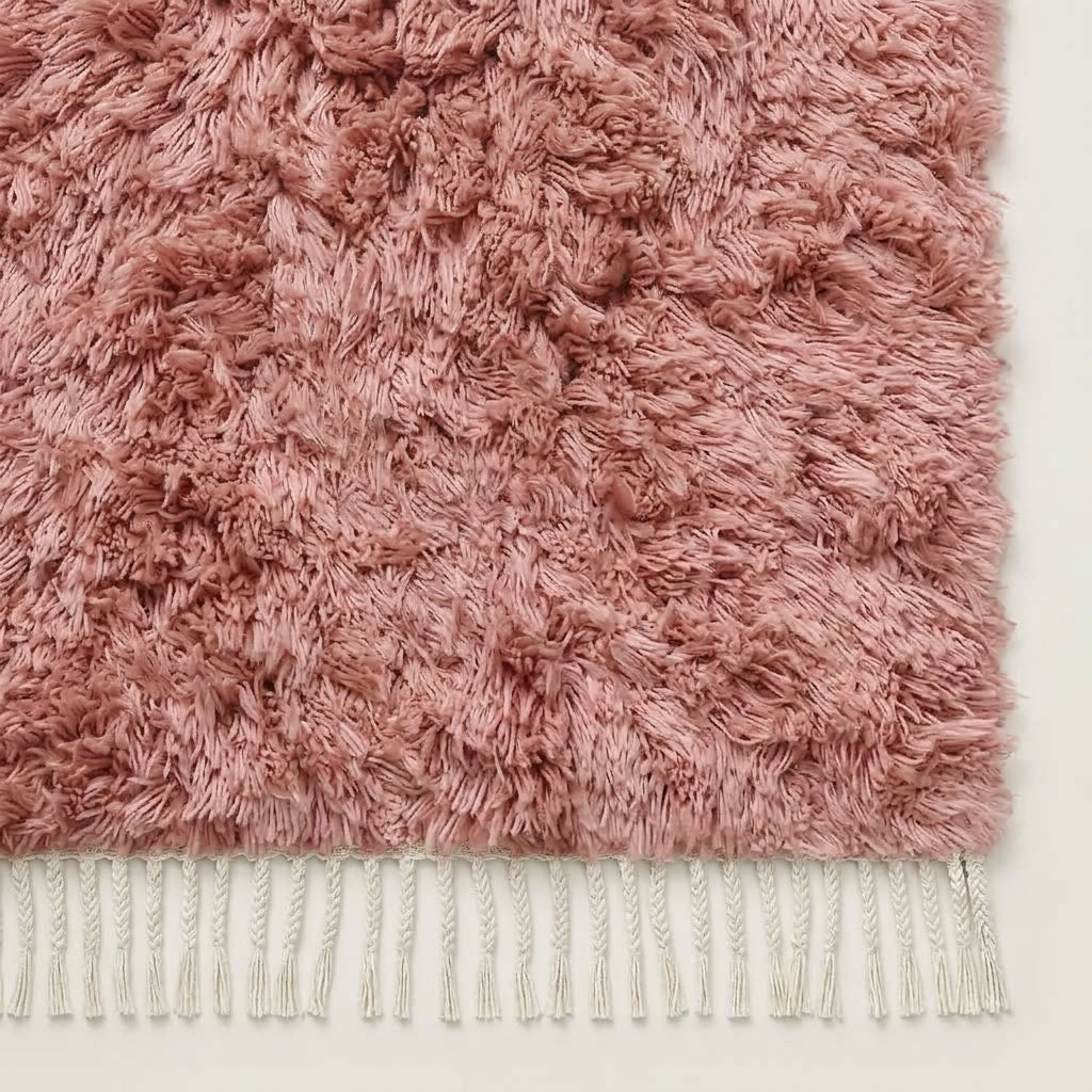 Detail of mauve Beni Ourain rug corner with ivory fringe and pile edge