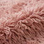 Close-up of dense mauve pile texture showing hand-knotted wool construction