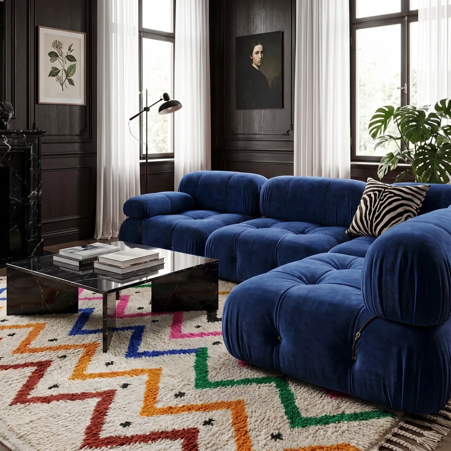 Rainbow zigzag Azilal rug in a living room with blue modern sofa, black coffee table and dark walls
