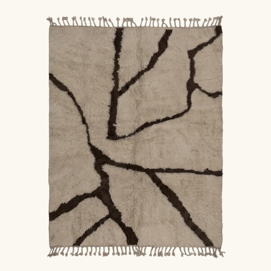 Full view of the Aylal mushroom and dark brown Beni Ourain rug with a branch line design.