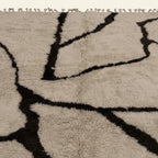 Close-up of the dark brown branch line pattern on the Aylal mushroom Beni Ourain rug.