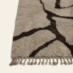 Fringe and edge detail of the Aylal mushroom and dark brown Beni Ourain rug.