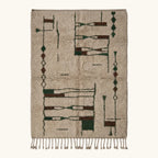 Full view of the Tafra mushroom, forest green and charcoal Beni Ourain rug with an abstract linear design.