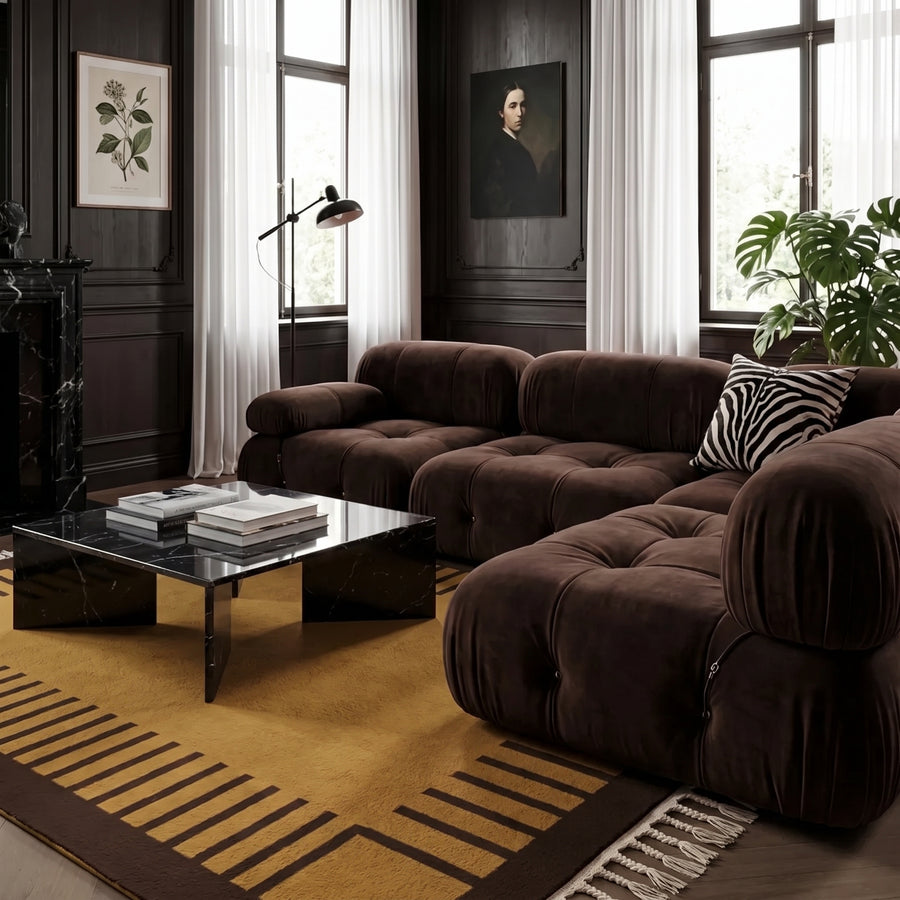 Mustard and chocolate Mrirt rug styled in contemporary living room with brown modular sofa and black marble table