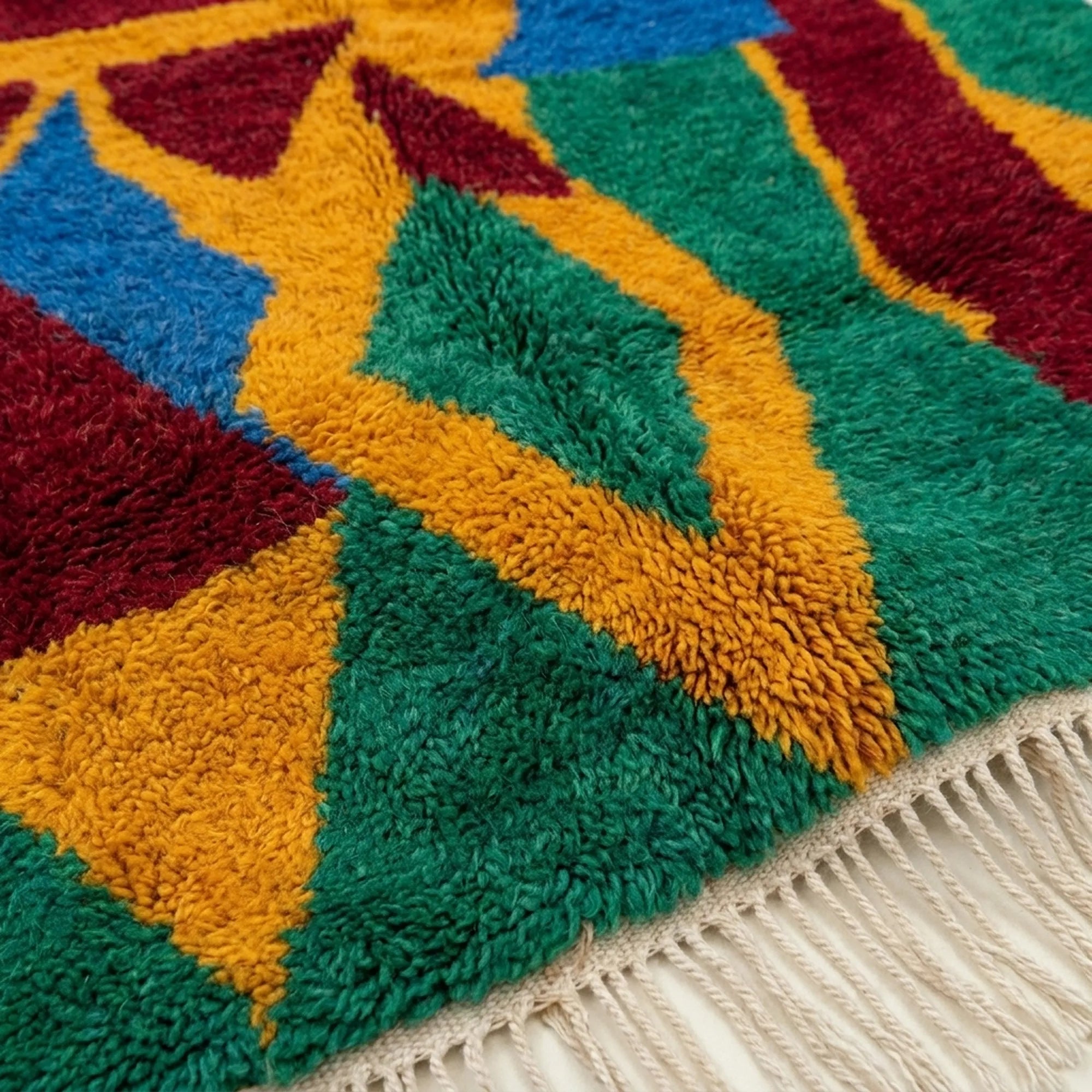Close-up of the Imazigh Boujaad rug showing plush mustard, green and cobalt hand-knotted wool pile