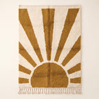 Mustard and ivory Beni Ourain rug with geometric sunburst design radiating from central semicircle, flat lay on plain background