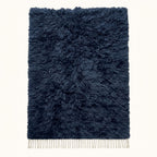 Navy Beni Ourain rug with soft textured monochromatic pile and cream fringe, full flat view