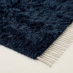 Navy Beni Ourain rug corner showing cream wool fringe and pile edge