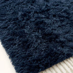 Detailed view of navy handwoven wool pile with natural texture variation