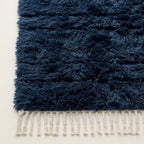 Detail of navy Tamazirt rug edge with ivory wool fringe