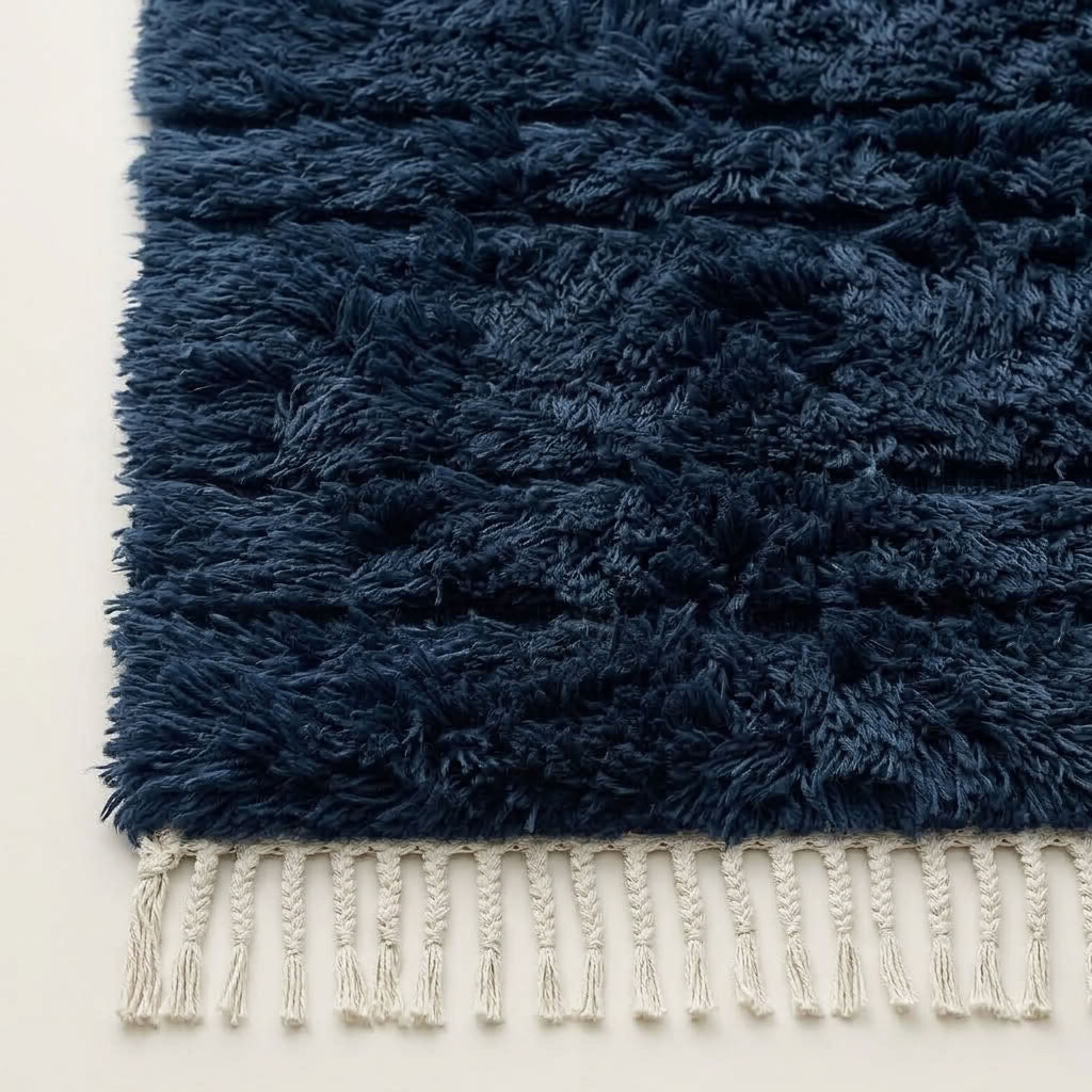 Detail of navy Tamazirt rug edge with ivory wool fringe