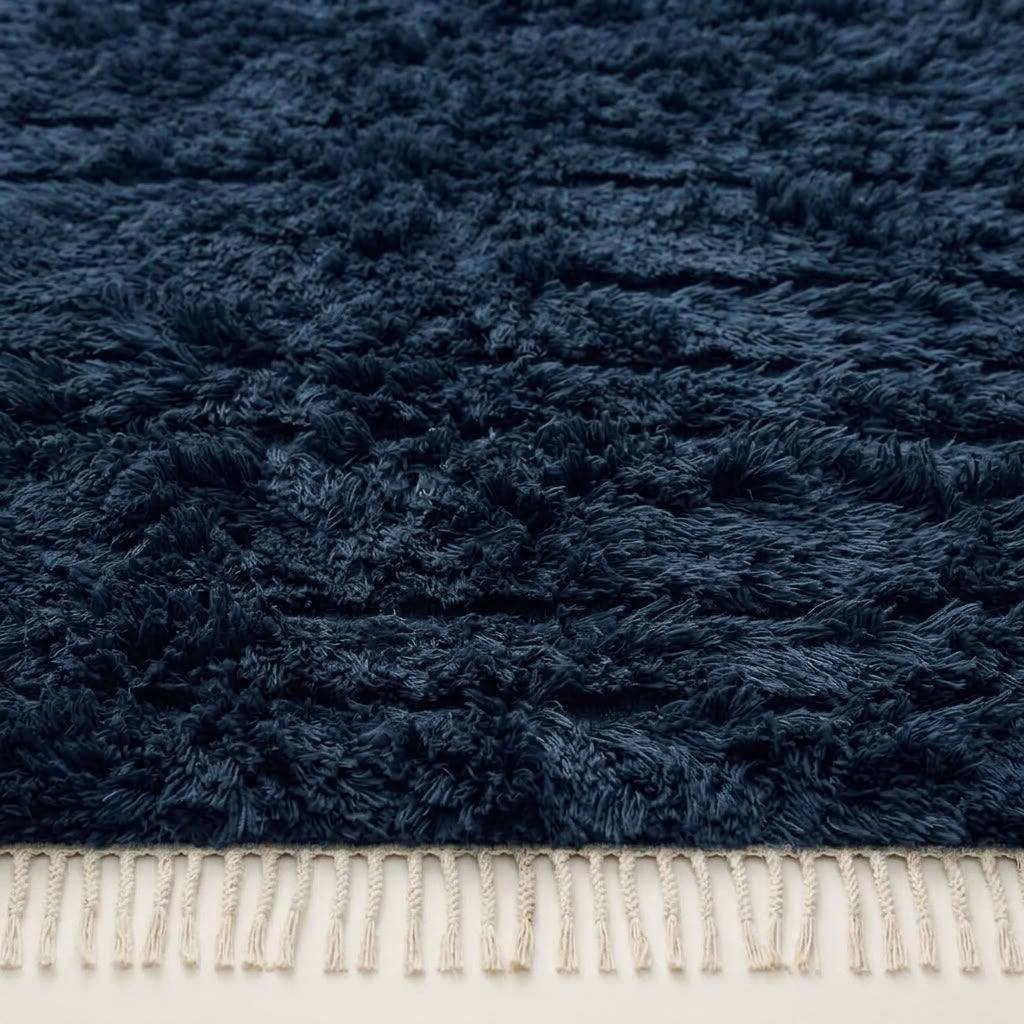 Close-up of horizontal band texture in navy wool pile showing subtle depth variation