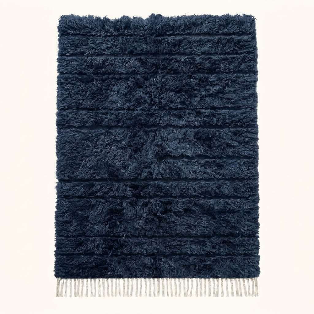 Navy Beni Ourain rug with textured horizontal bands, ivory fringe, flat view on plain background