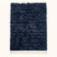 Navy Beni Ourain rug with textured horizontal bands, ivory fringe, flat view on plain background