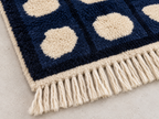 Cream wool fringe edge detail of navy and cream Mrirt runner