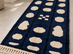 Navy and cream pebble columns runner in interior setting showing full length and fringe