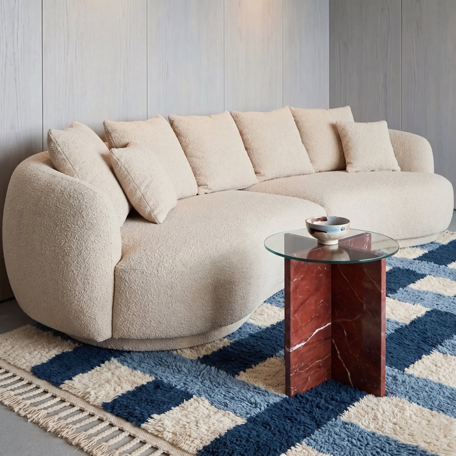 Navy and ivory cross grid Beni Ourain rug in living room under modern curved sofa