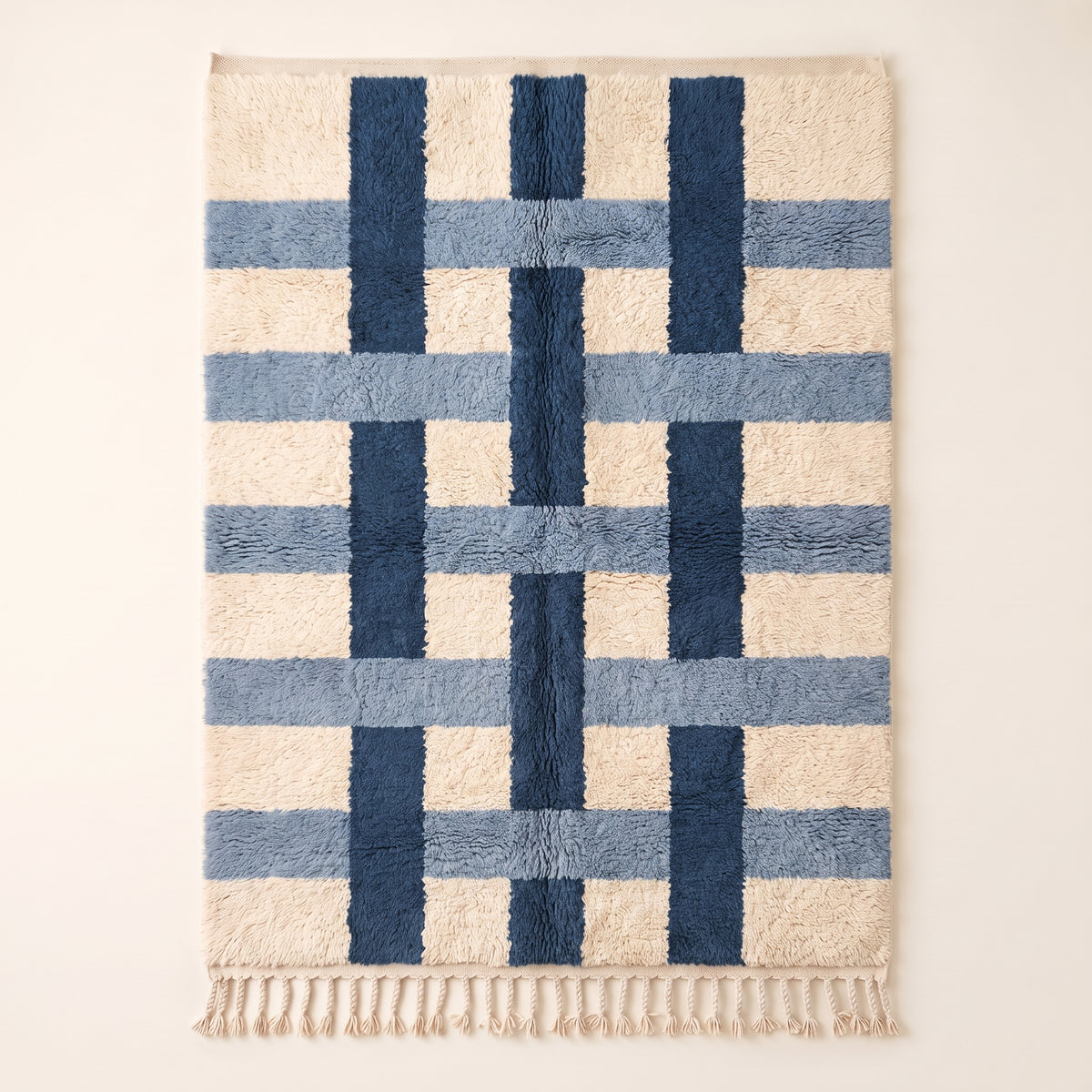 Navy and ivory Beni Ourain rug with cross grid pattern formed by thick intersecting bands on plain background