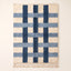Navy and ivory Beni Ourain rug with cross grid pattern formed by thick intersecting bands on plain background