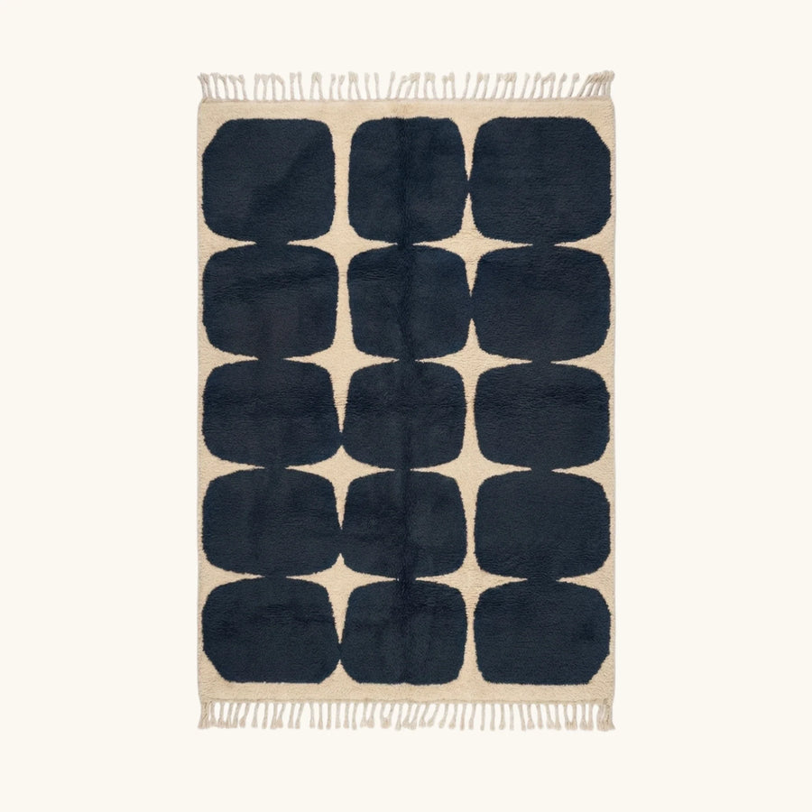 Full view of the Tamazirt navy and ivory Beni Ourain rug with a rounded grid design.