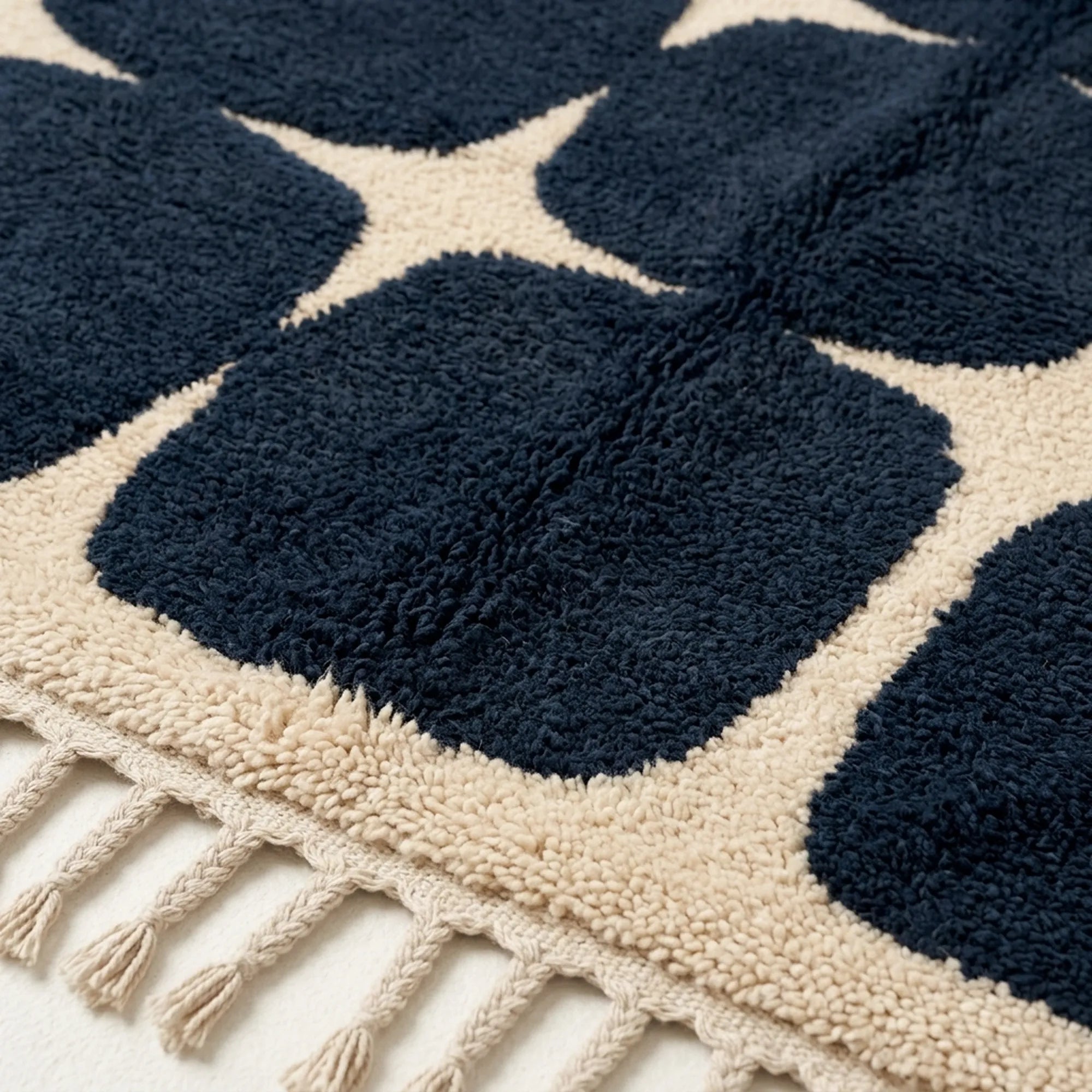 Border detail of the Tamazirt navy and ivory rounded grid rug.