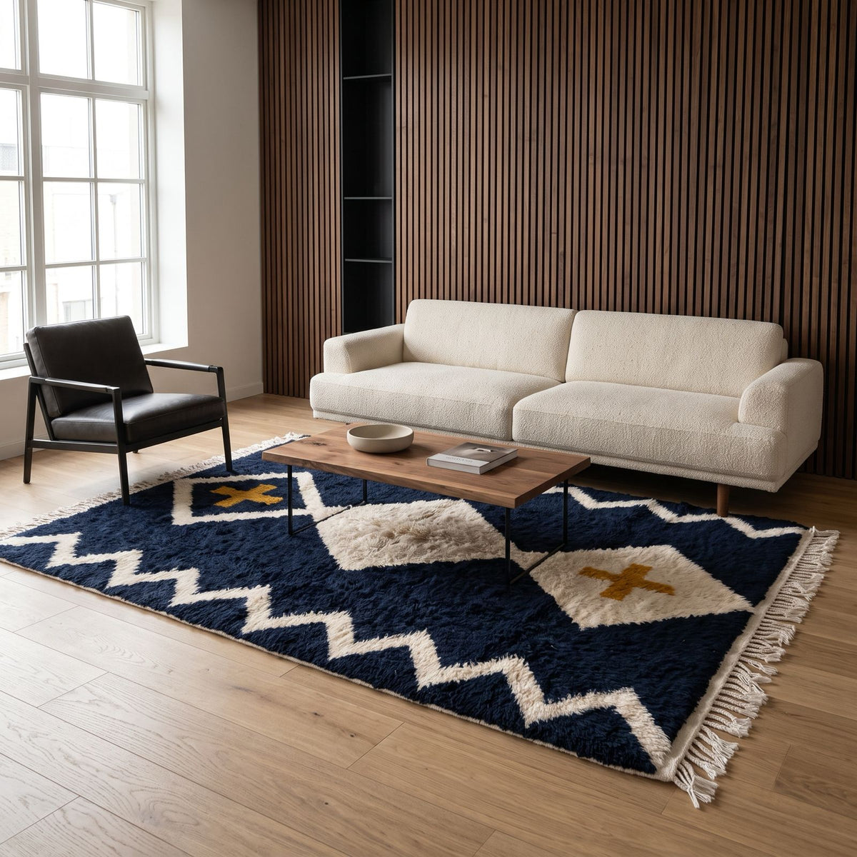 Navy and ivory Beni Ourain rug in living room with cream sofa and black chair