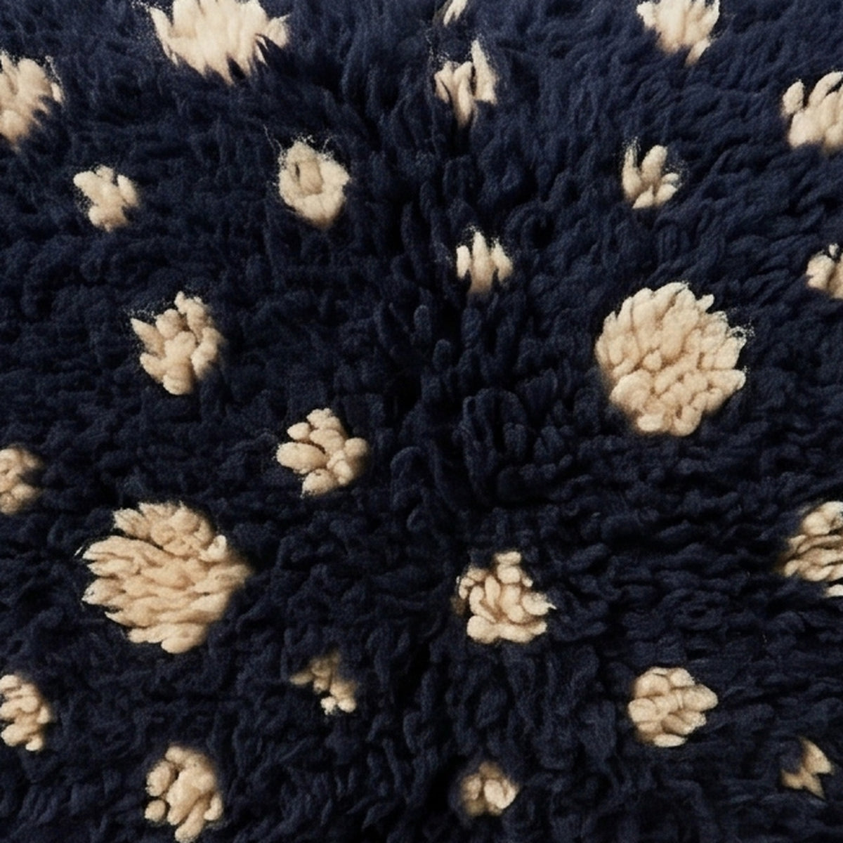 Close-up of the navy snow pattern on the Adfel Moroccan wool pillow
