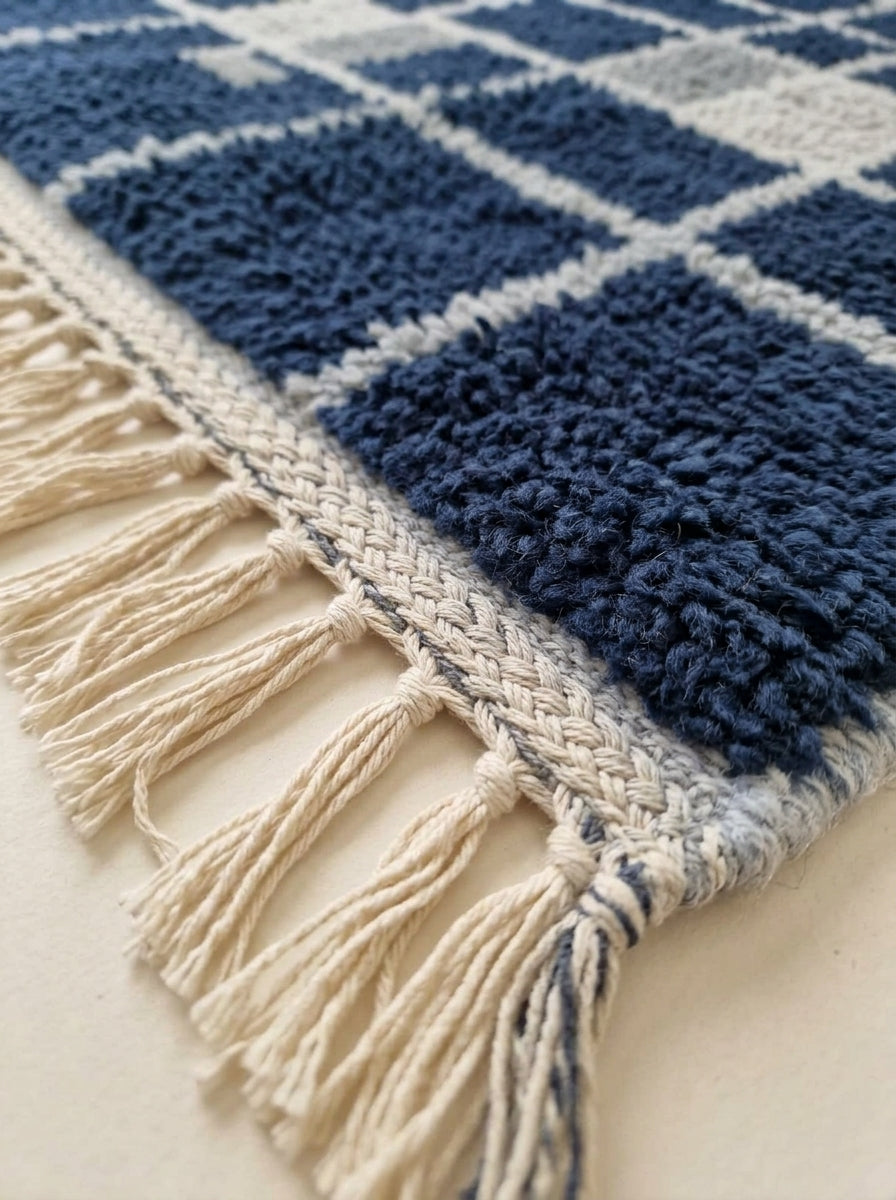 Cream wool fringe detail at end of navy and ivory Mrirt runner with woven selvedge edge