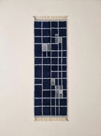 Navy and ivory Mrirt runner with grid check pattern, flat lay on white background