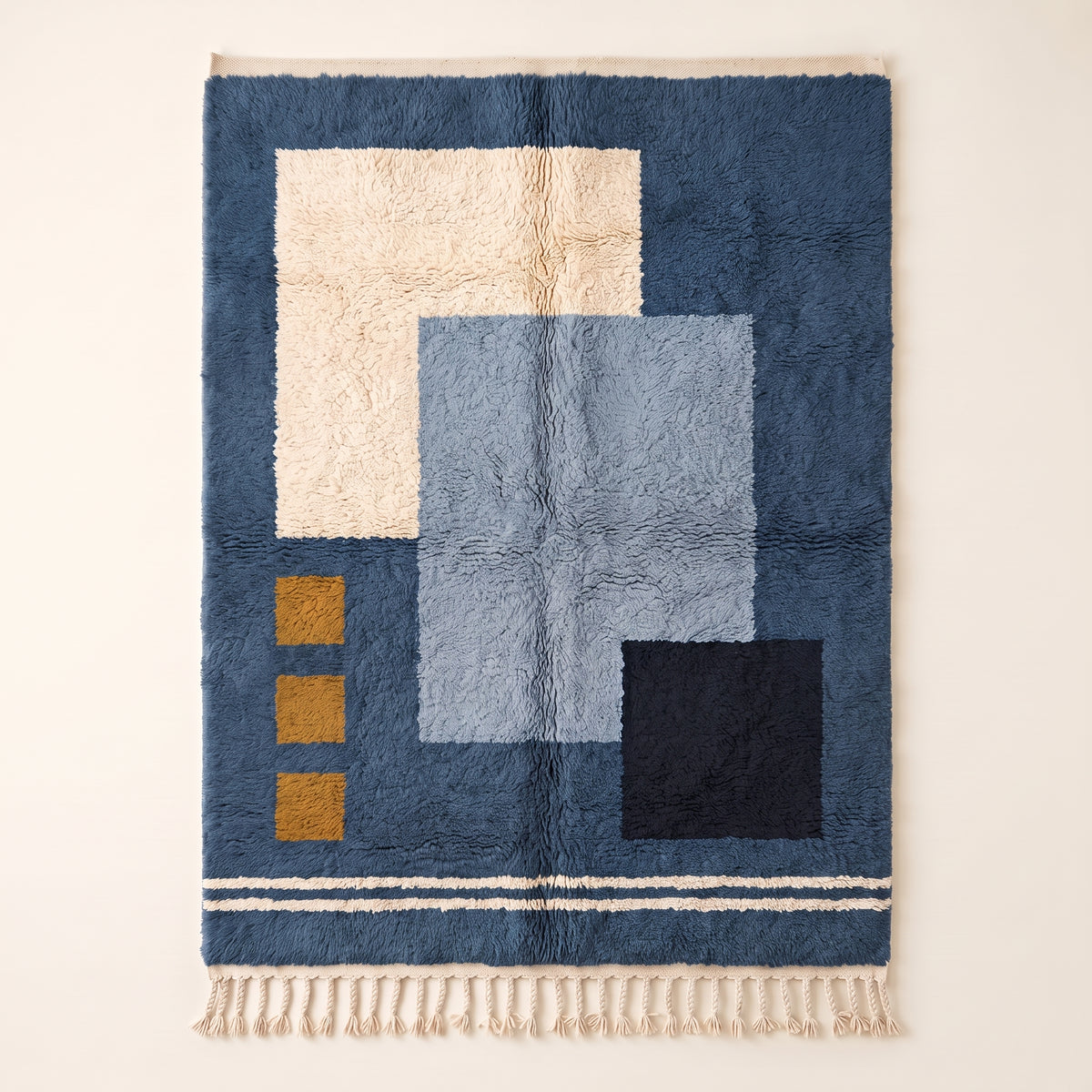 Navy, ivory, slate blue and gold Mrirt rug with color-block geometry design and gold square accents, flat lay view