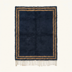 Full view of the Isli navy and ochre Beni Ourain rug with an ivory double border.