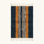 Full view of the Tifrit navy, ochre and ivory Beni Ourain rug with a central stripe design.