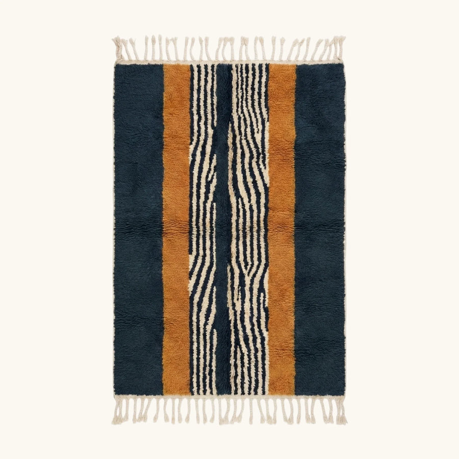 Full view of the Tifrit navy, ochre and ivory Beni Ourain rug with a central stripe design.