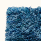Angled view of navy and pale blue Beni Ourain pile on rug Itri showing three-dimensional textured surface