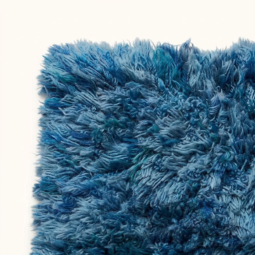 Angled view of navy and pale blue Beni Ourain pile on rug Itri showing three-dimensional textured surface
