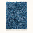Navy and pale blue Beni Ourain rug Itri with textured diamond lattice, flat lay on plain background