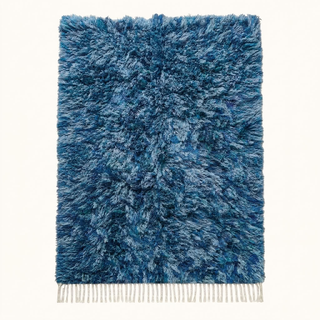 Navy and pale blue Beni Ourain rug Itri with textured diamond lattice, flat lay on plain background