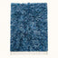 Navy and pale blue Beni Ourain rug Itri with textured diamond lattice, flat lay on plain background