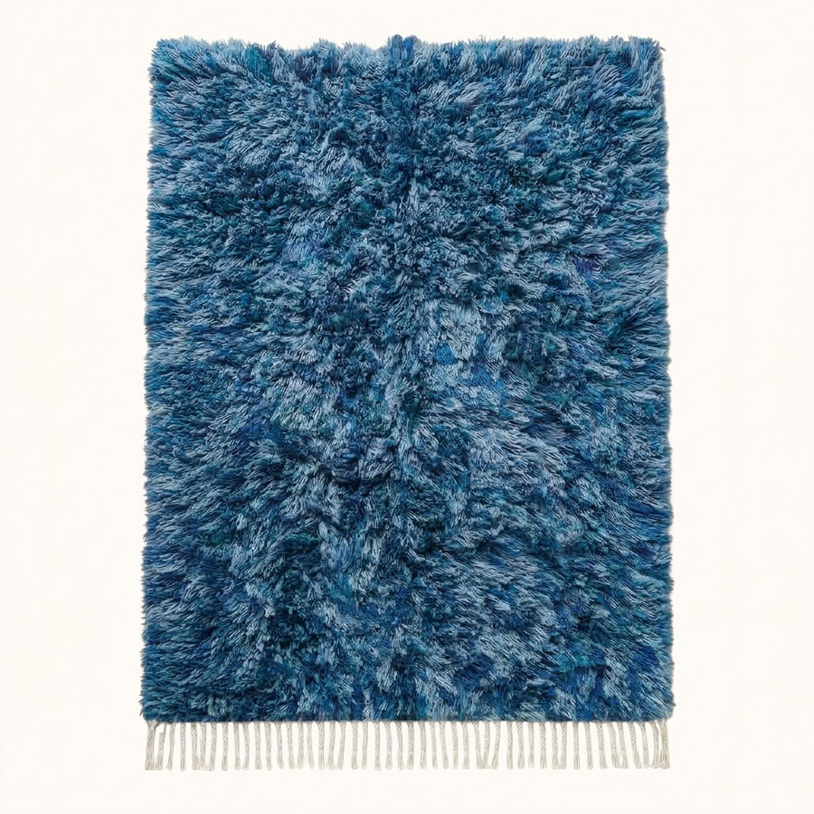 Navy and pale blue Beni Ourain rug Itri with textured diamond lattice, flat lay on plain background