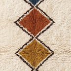 Detailed view of Tafrara terracotta and gold stacked diamonds with dark brown outlines and soft pile finish