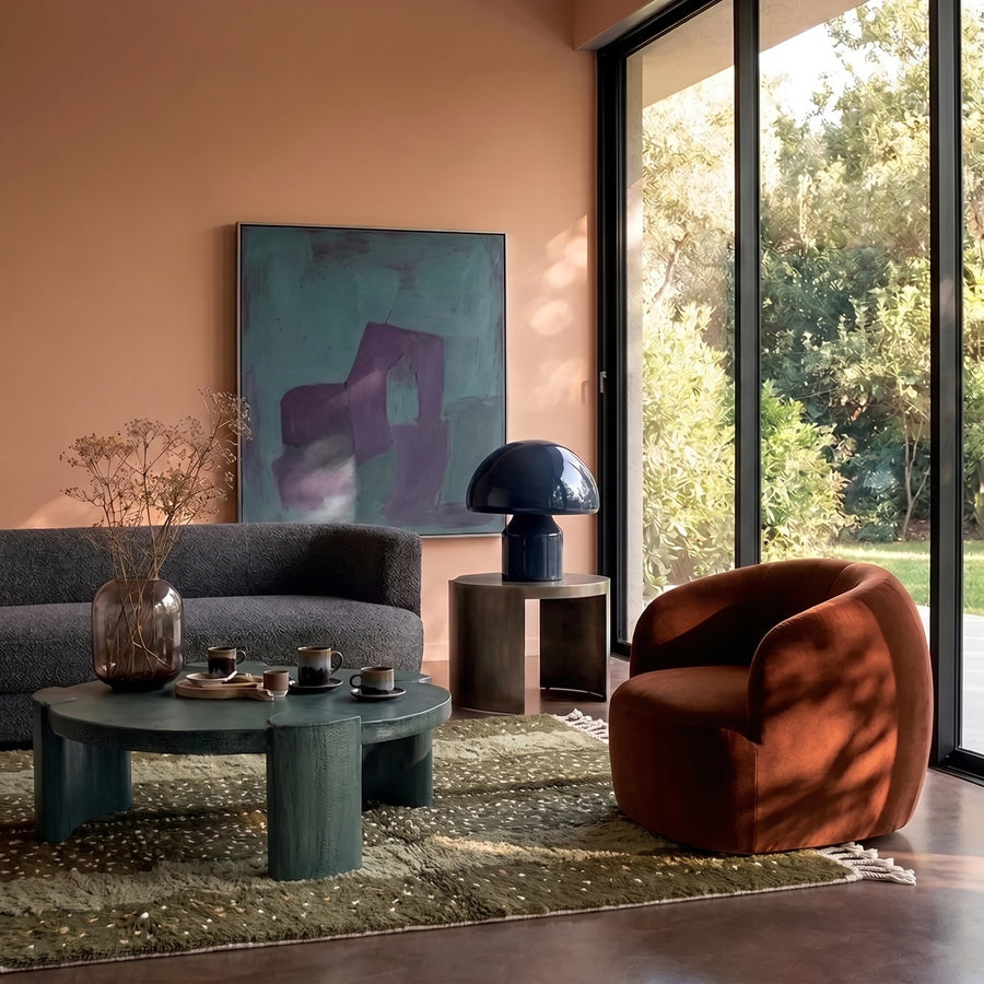 Olive and fawn Mrirt rug in modern living room with terra cotta walls and contemporary furniture