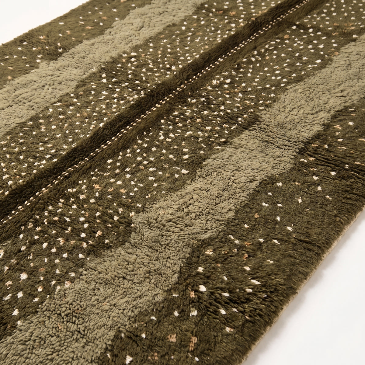 Close-up of scattered dot stripe pattern showing plush pile texture and olive fawn color transition