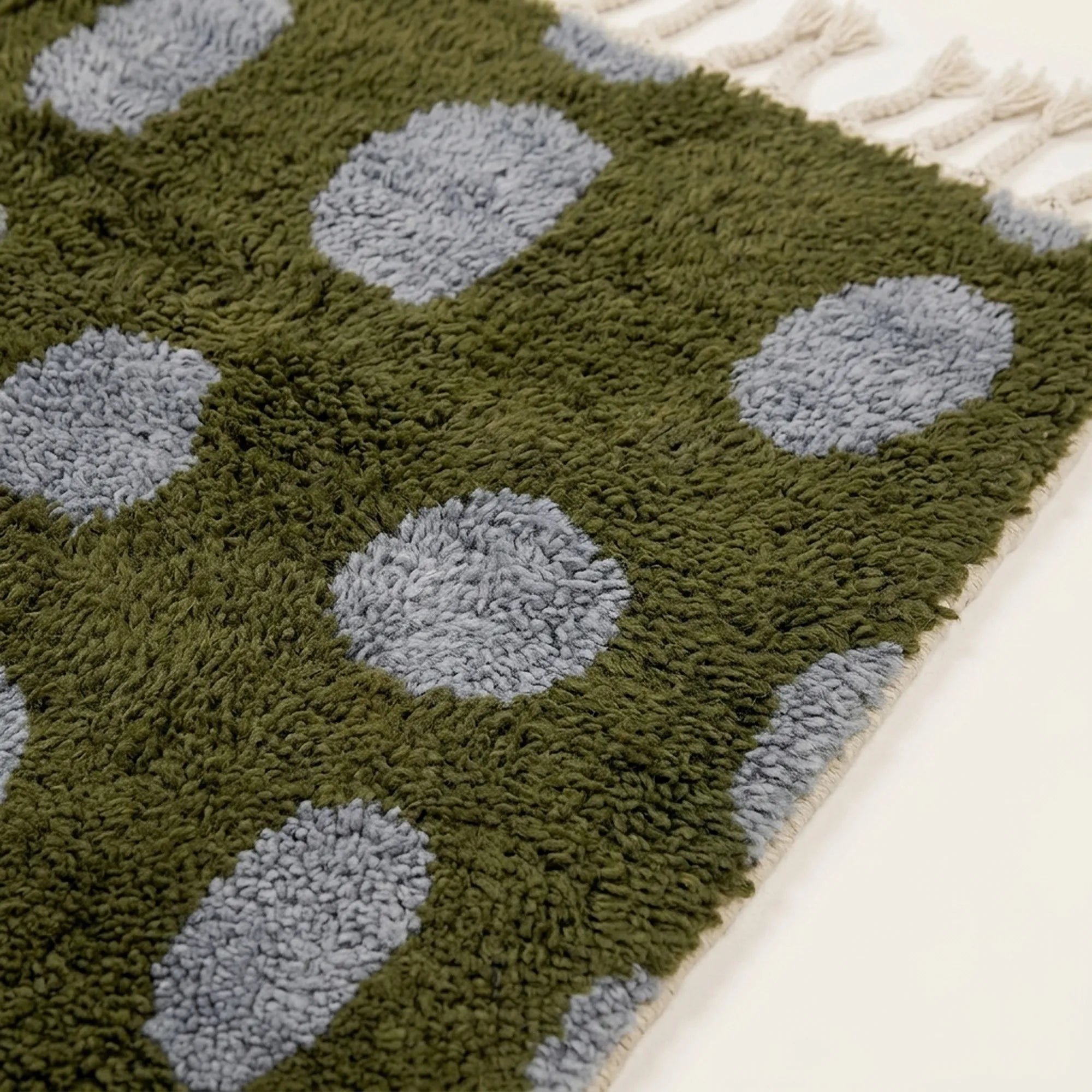 Close-up of the slate blue oval grid pattern on the Azil olive green Beni Ourain rug.