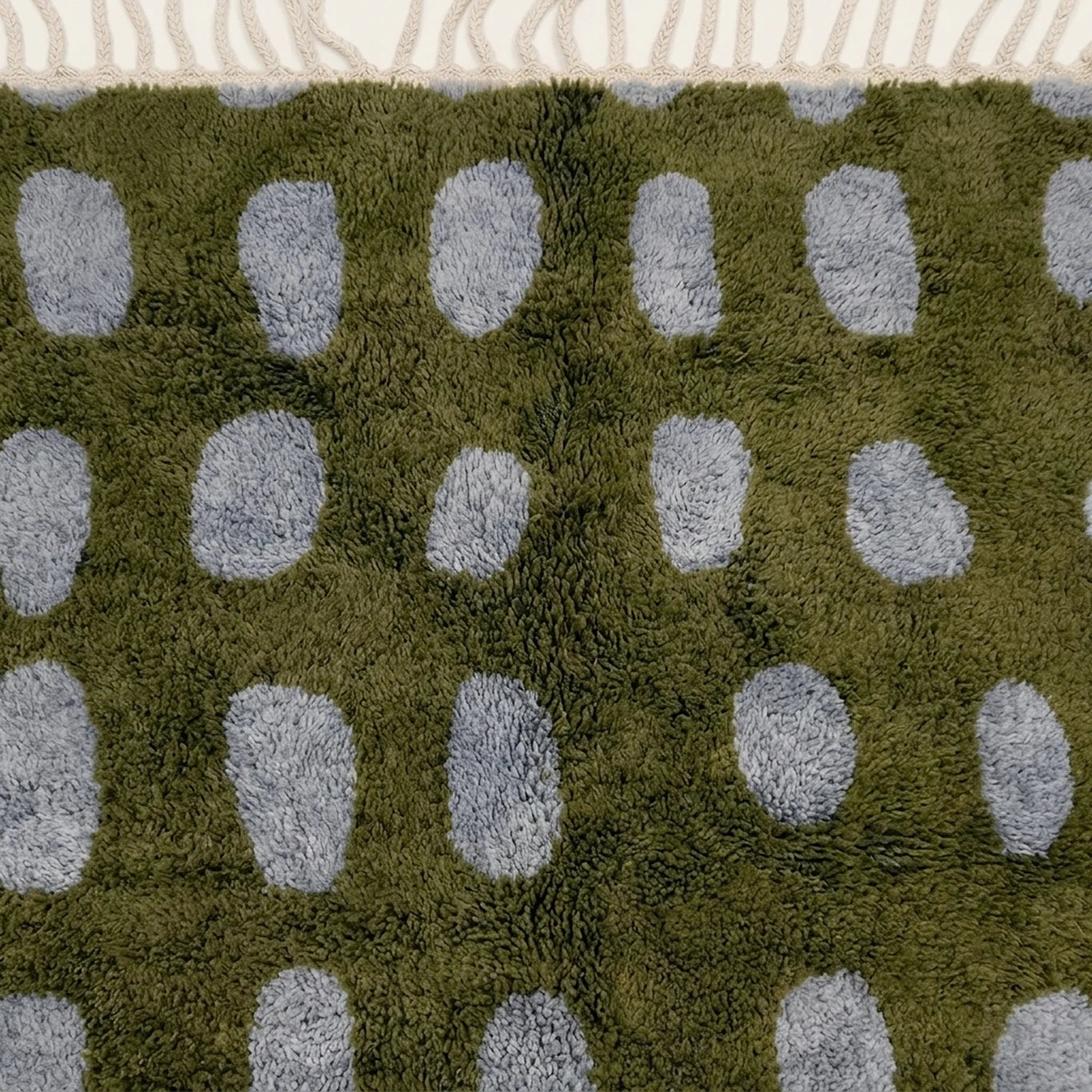 Close-up of the natural Atlas wool pile on the Azil olive green and slate blue Beni Ourain rug.