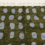 Fringe and edge detail of the Azil olive green and slate blue Beni Ourain rug.