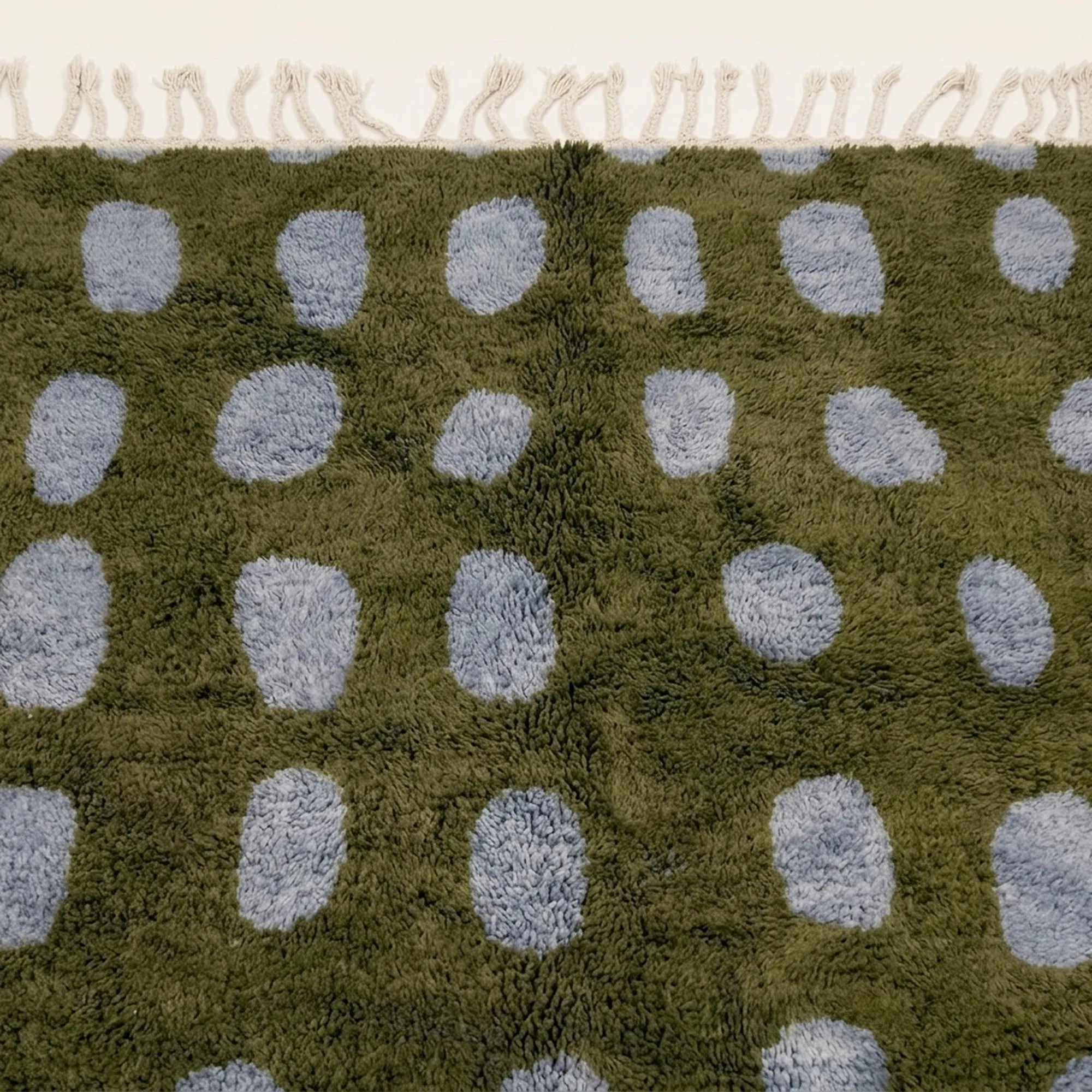 Fringe and edge detail of the Azil olive green and slate blue Beni Ourain rug.