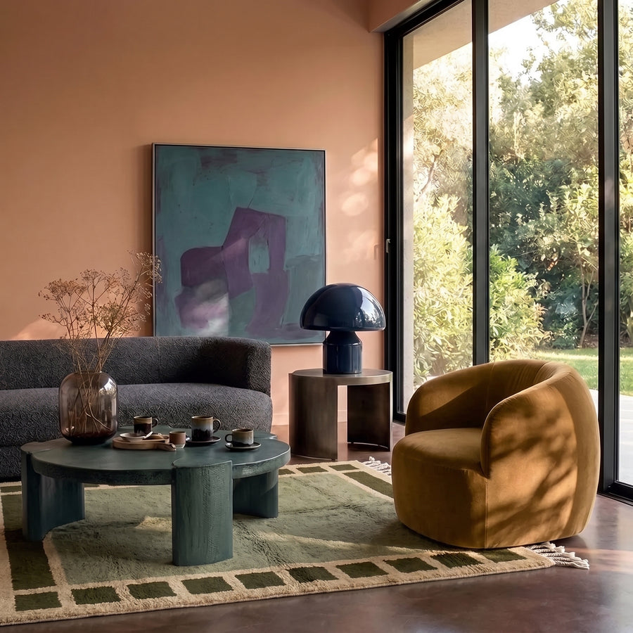 Olive Mrirt rug in modern living room with gold chair and teal coffee table