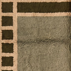 Side view of olive Mrirt rug showing dense plush pile and border frame